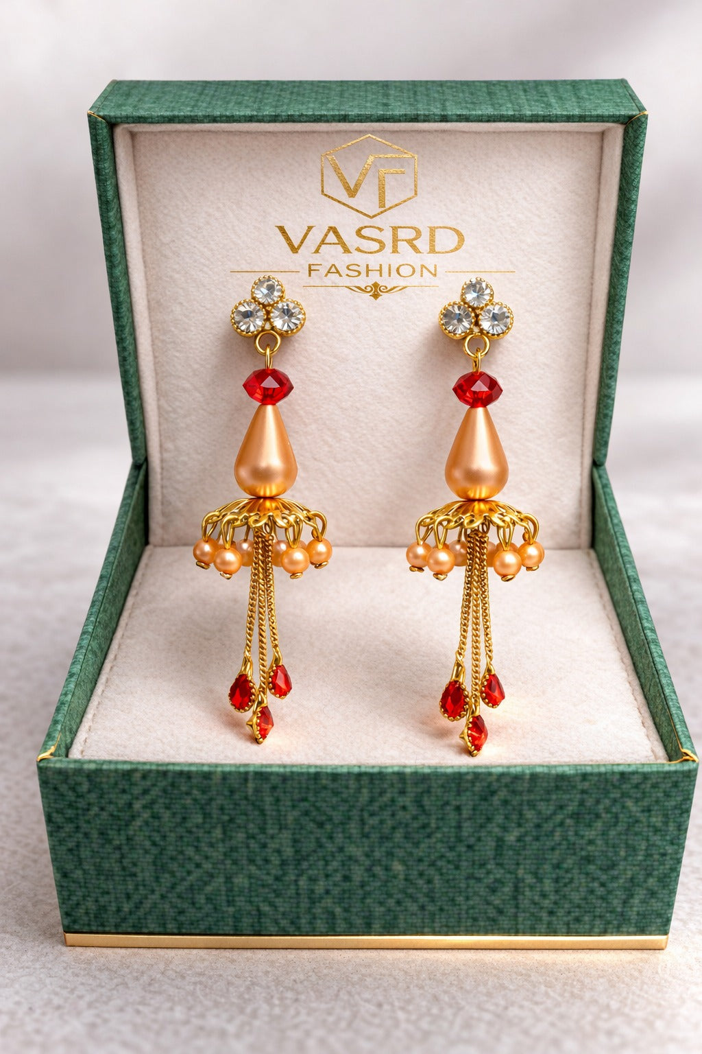Elegant Gold Jhumka Earrings with Red Crystal Drops and Chain Tassels