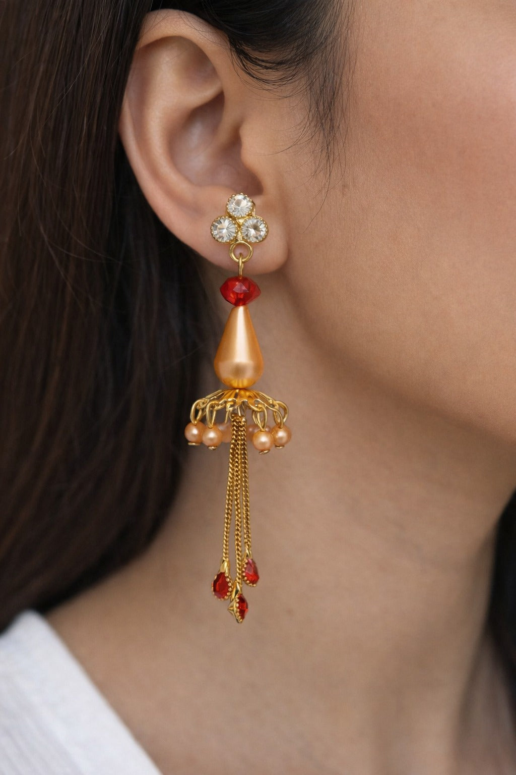 Elegant Gold Jhumka Earrings with Red Crystal Drops and Chain Tassels