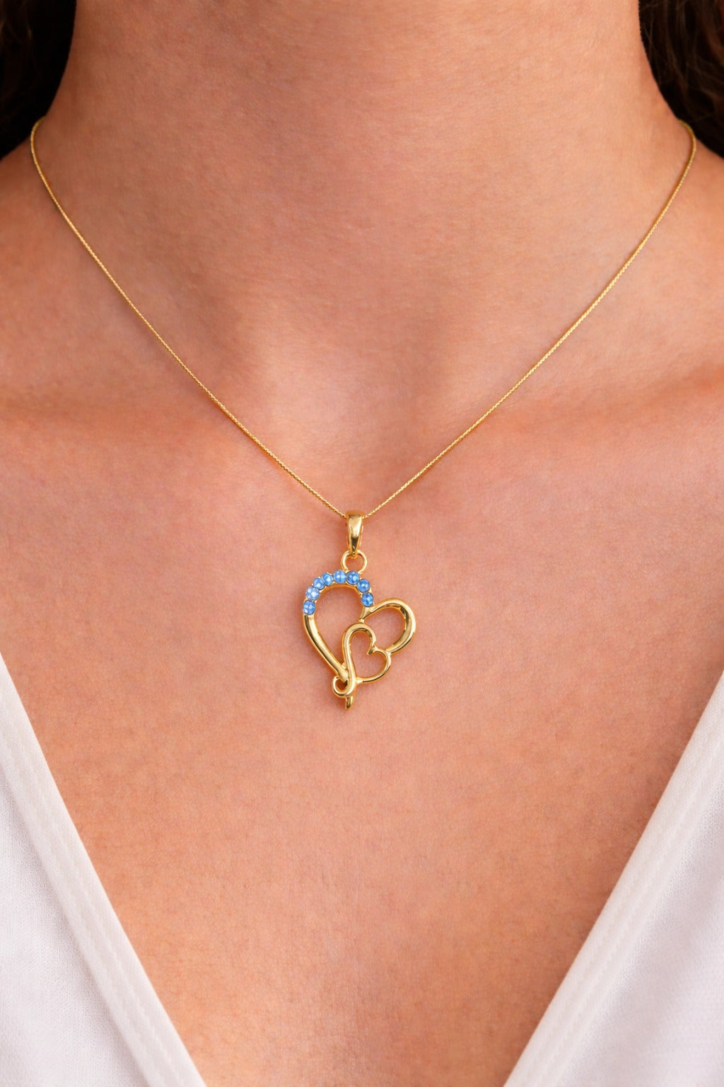 Elegant Gold Heart Pendant Necklace with Blue Gem Accents on Delicate Chain